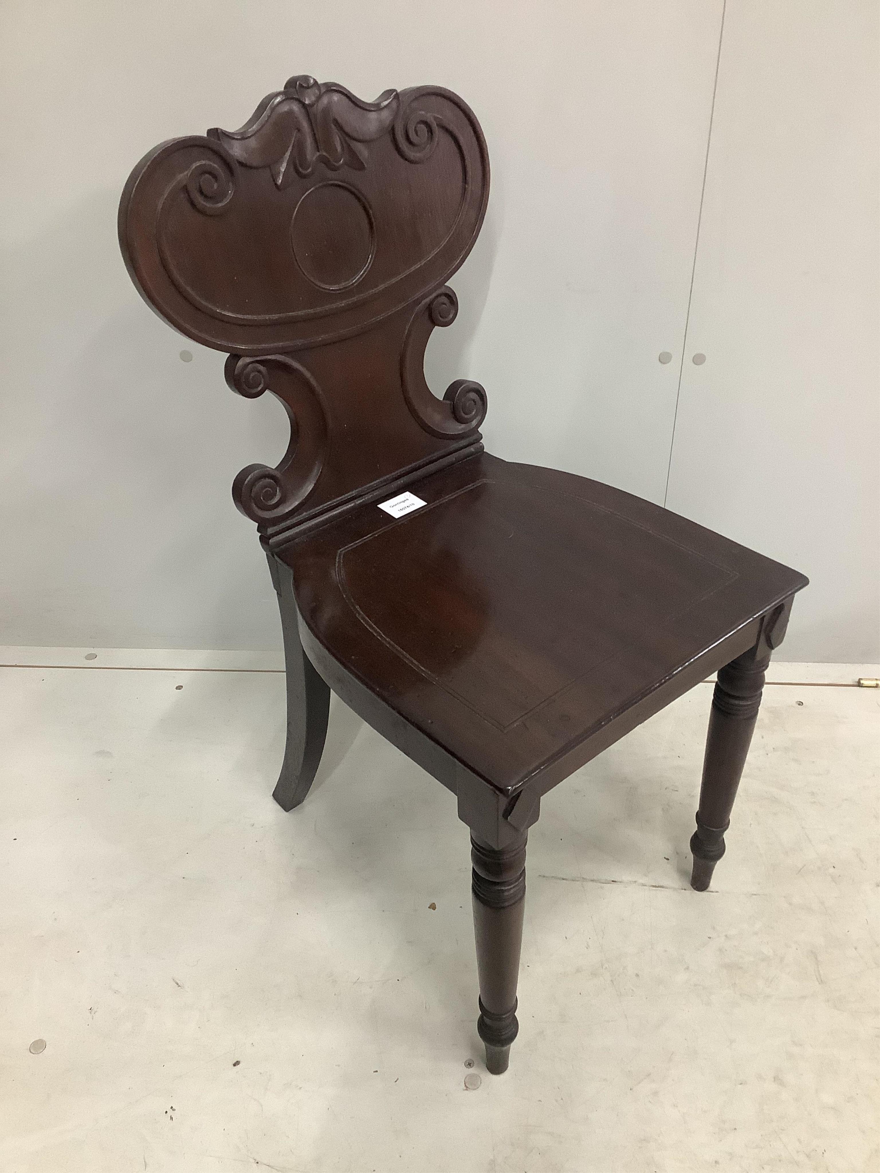 An early Victorian mahogany hall chair and a Continental inlaid oak spinning chair. Condition - both fair to good